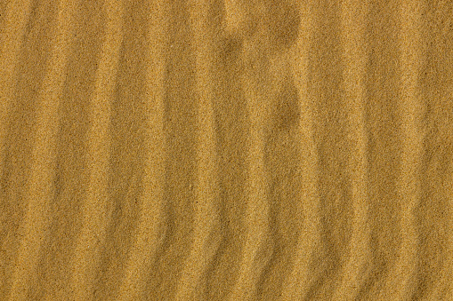 Wavy parallel pattern on the sand on the beach