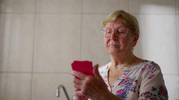 istock Tech-savy senior woman using phone. Elderly 80s female person holding cellphone device 1623117885