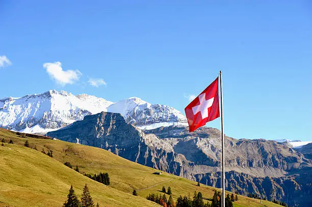 Swiss flag in front of the Wildstrubel mountain in the Bernese Alps