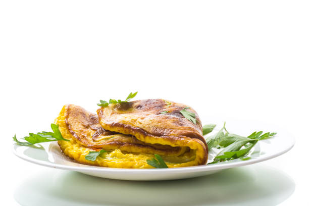 Fried omelette with zucchini,in a plate on a white background. stock photo