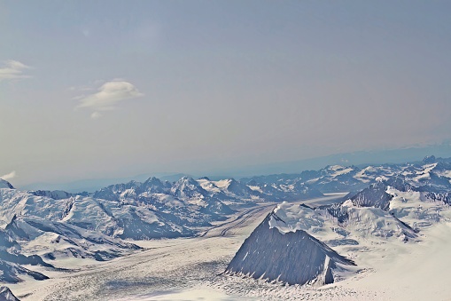 Aerieal view of peaks and valleys of Denali National Park mountain range with blue skies and copy space, Alaska.