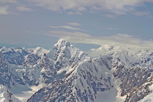 Aerieal view of peaks and valleys of Denali National Park mountain range with blue skies and copy space, Alaska.