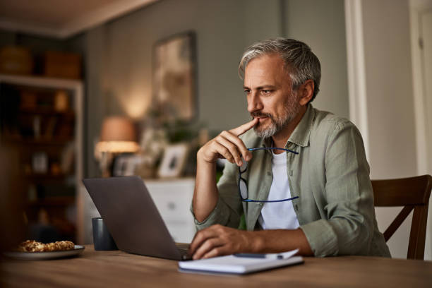 istock A thoughtful male freelancer reading an online document on a laptop at home. 1623133192