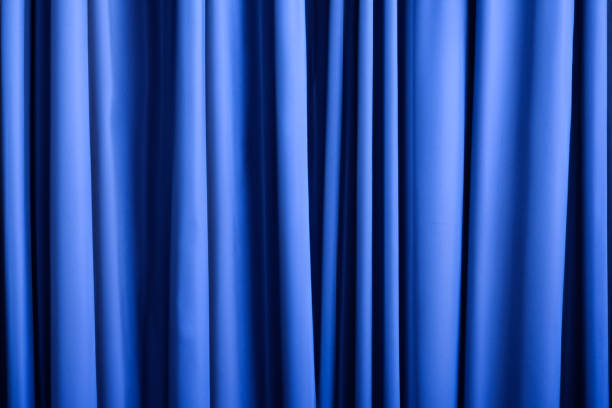 istock closeup of blue curtains textured background 1623160320
