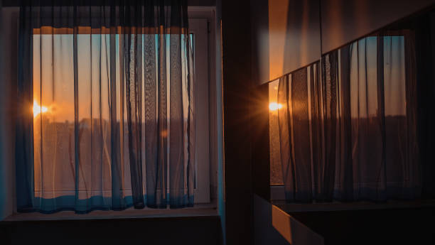 istock Window with curtain and sunlight reflecting on cabinet in room 1623164732
