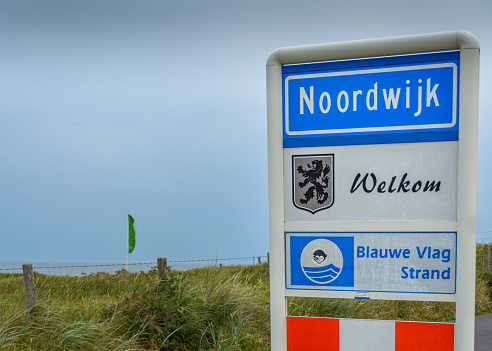 Noordwijk, The Netherlands - June 28, 2015: Welcome sign Noordwijk at the Blue Flag beach on a windy gray day