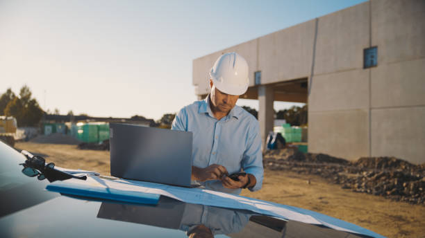 istock Male building contractor using mobile phone at construction site 1623196424