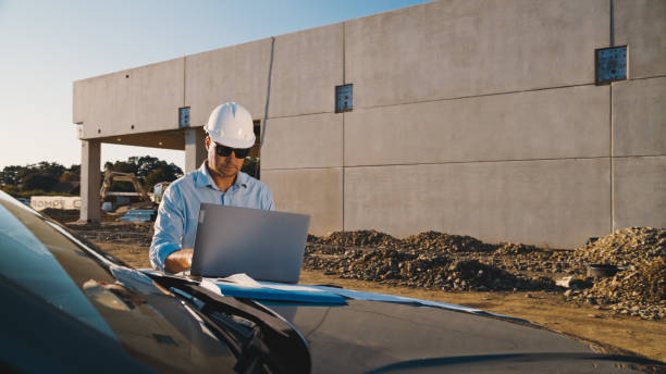 istock Mature male architect working on laptop near construction building 1623196954