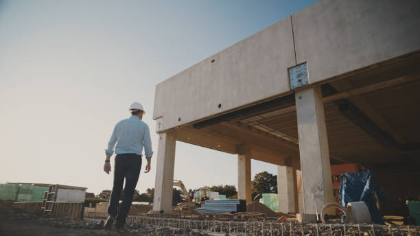 istock Mature male building contractor walking towards under development site 1623197334