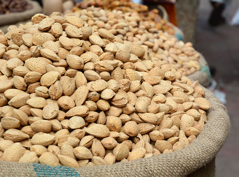 Dried almonds for sale at local market in Old Delhi, India.