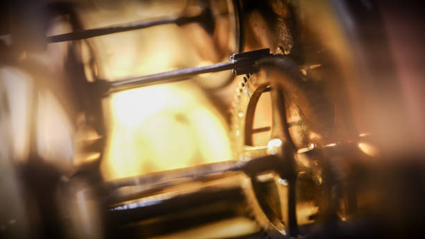 The gold gears in the old clock mechanism are intricately connected,forming a symphony of interlocking cogs that work together harmoniously