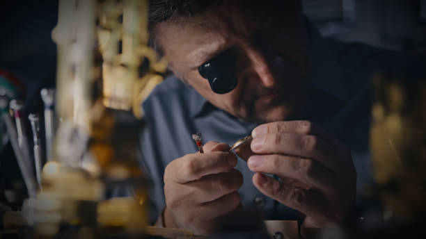 istock Mechanic wears a magnifying glass while analyzing the gear at workplace 1623204968