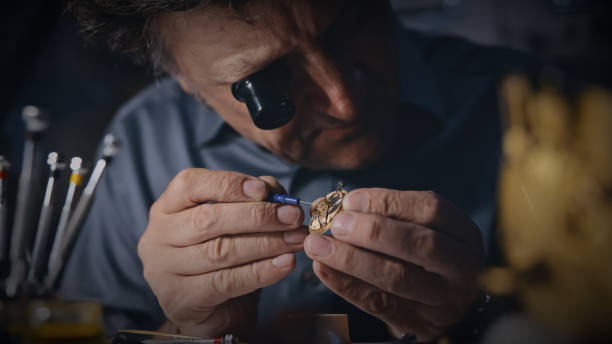 istock Mature craftsman wears a magnifying glass while fixing the gear 1623205044