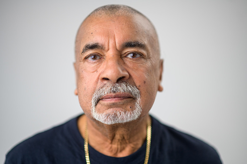 Senior Multiracial Male with goatee beard and blue brown eyes extreme Close-Up Studio Headshot Neutral Look Portrait