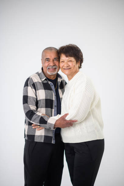 istock Senior Multiracial Couple Studio Portrait Smiling Looking at Camera 1623205831