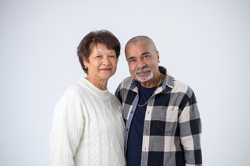 Beautiful Multiracial Senior Couple in love Studio Portrait Looking at camera friendly