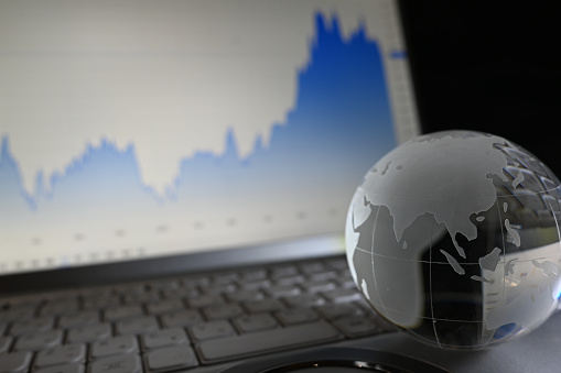 Glass globe with graphs of stock prices