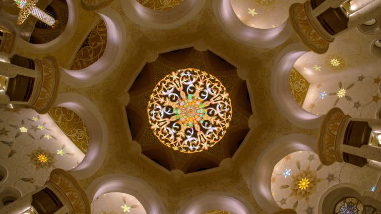 4K Time lapse interior of Sheikh Zayed Grand mosque at night, chandelier view from low angle.