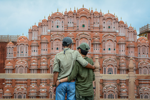 Jaipur, India - Jul 27, 2015. A young couple standing and looking at Hawa Mahal (Wind Palace) in Jaipur, India.