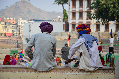 Pushkar, India - Nov 5, 2017. Indian men sitting and chatting on street in Pushkar, India.