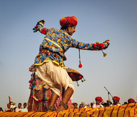 Pushkar, India - Mar 7, 2012. Rajasthani folk dancers in colorful ethnic attire perform in Pushkar, India. Pushkar is one of the most ancient cities of India.
