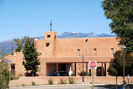La Fonda hotel, in traditional adobe style, located on Santa Fe Plaza in downtown Santa Fe New Mexico on a sunny day.