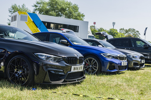 Tarporley, Cheshire, England, June 3rd 2023. Row of BMWs at a car meet, automotive lifestyle editorial illustration.