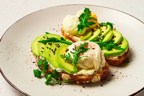 istock sandwich with cream cheese, sliced avocado and boiled egg, arugula, on grainy bread, homemade, breakfast, no people, 1623240079