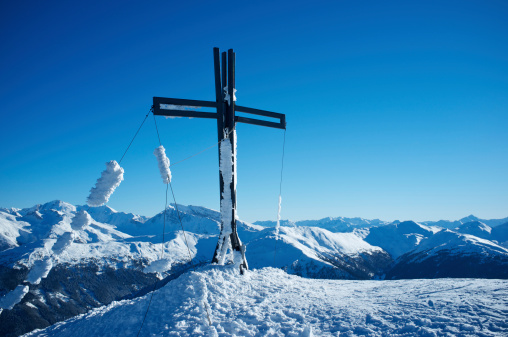 Mountain summit cross on top of a mountain in the Austrian Alps