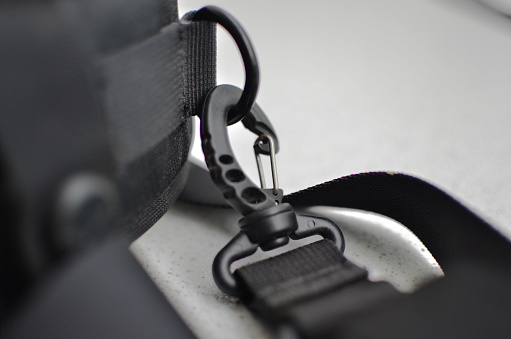 Black suspender or belt close-up, elegant and high-quality accessory to complete your style. Concept for backpacks or military accessories.