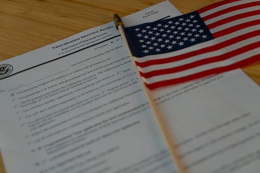 Naturalization interview results, USCIS form N - 652 Next to the flag of USA