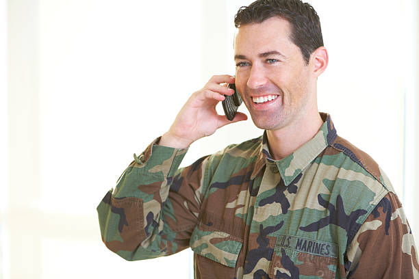 istock White male in army uniform on cell phone 162327030