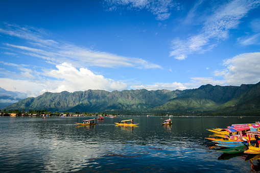 Wooden boats on Dal Lake at sunny day in Srinagar, India. Srinagar is the summer capital of the Indian state of Jammu and Kashmir.
