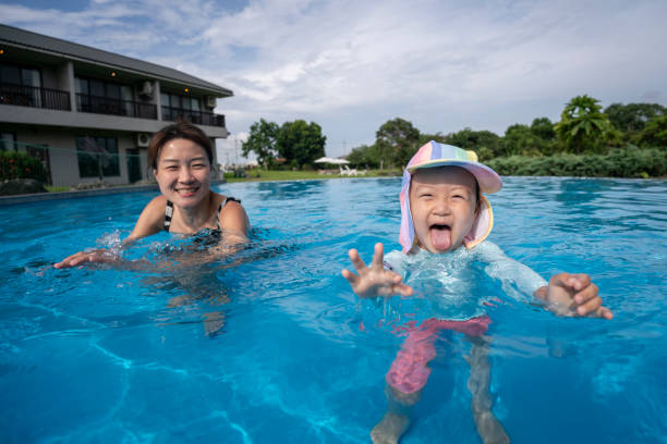 istock Chinese mother playing with daughter in pool 1623301148