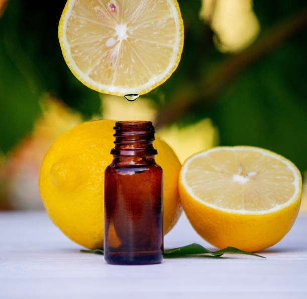 istock lemon essential oil and lemon fruit on a wooden white board. 1623313384