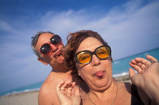 Senior couple with sunglasses having fun at the beach, Hollywood Beach, Florida, USA