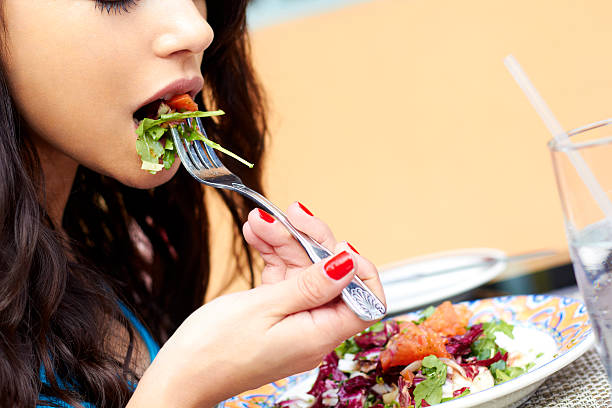 istock Young Attractive Woman Eating Salad 162331790