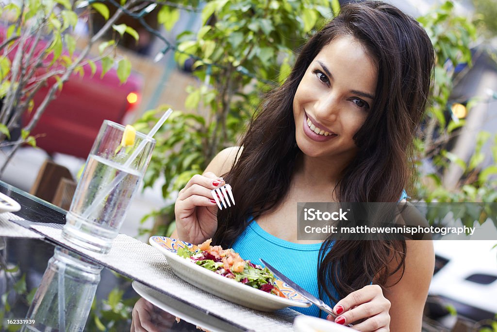 Young Attractive Woman Eating Salad Portrait of a young attractive woman eating salad at cafe table. Horizontal shot. 20-24 Years Stock Photo