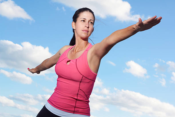 istock Young Woman Doing Yoga Warrior Pose 162332198