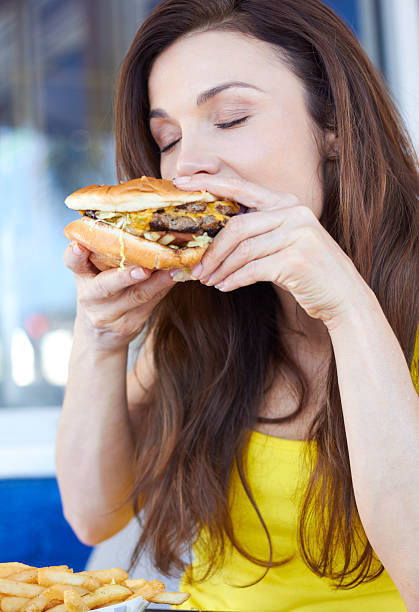 istock Young Lady Enjoying a Delicious Hamburger 162332264