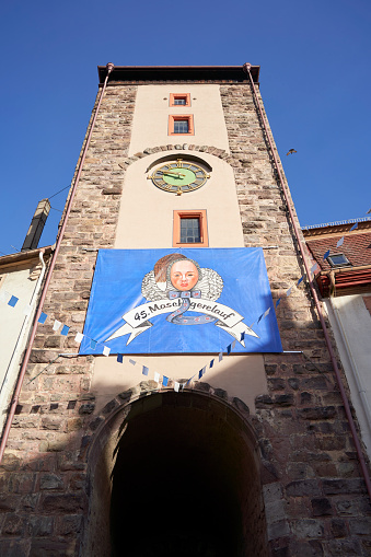 Villingen, Germany - February 20, 2023: City tower with gate at carnival. Decorated building with banner for parade. Black forest.