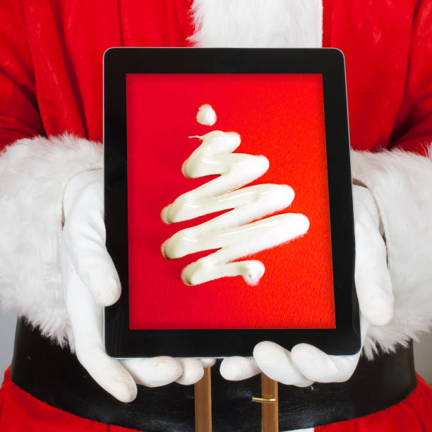 Santa Showing a Christmas tree in to his Digital Tablet