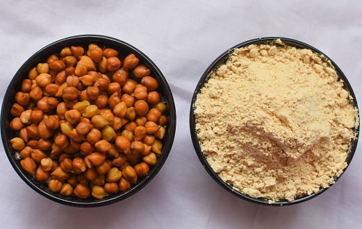 Sattu cha Peeth is a flour, mixture of roasted ground pulses and cereals. Traditional and nutritional food supplement from India. Served over white background. selective focus