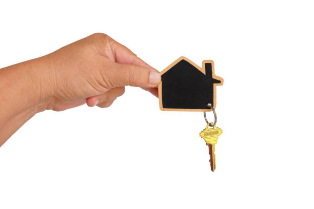 istock The hand holds the house with keychain.clipping path. 1623413211