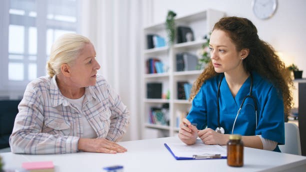 Senior woman complaining about kidney or stomach pain to female therapist Senior woman complaining about kidney or stomach pain to female therapist anamnesis stock pictures, royalty-free photos & images