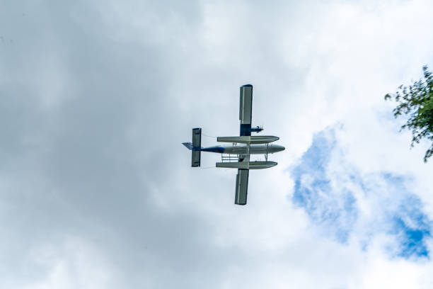 A seaplane flying over Devonian Harbour Park and Stanley Park, Vancouver, Canada.
