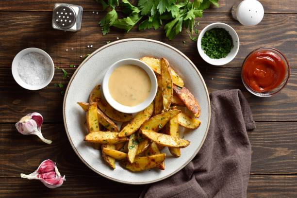 istock Baked potato wedges with sauce 1623484051