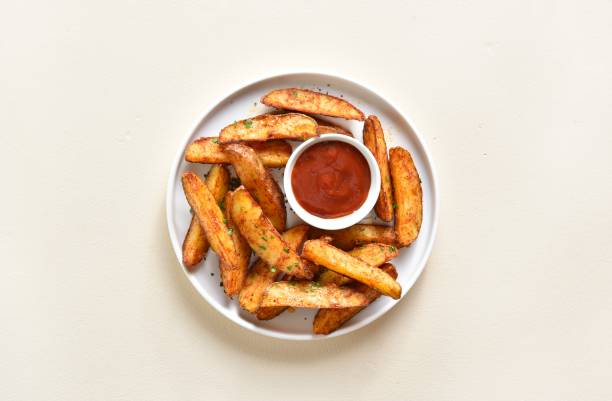 Oven baked potato wedges with sauce stock photo