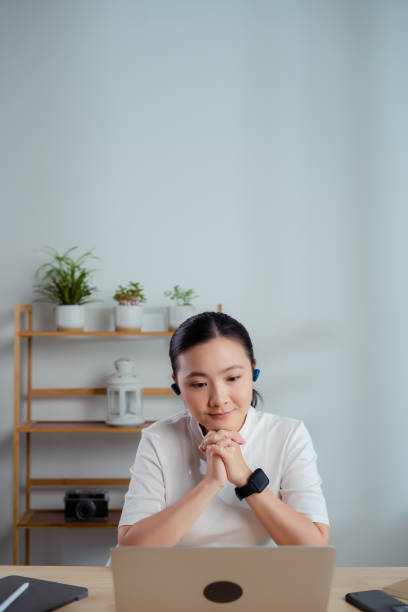 istock Asian woman enjoy with working online using laptop talking on video conference sitting at home office. 1623487546