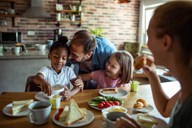 istock Young mixed family having breakfast together at home 1623500303